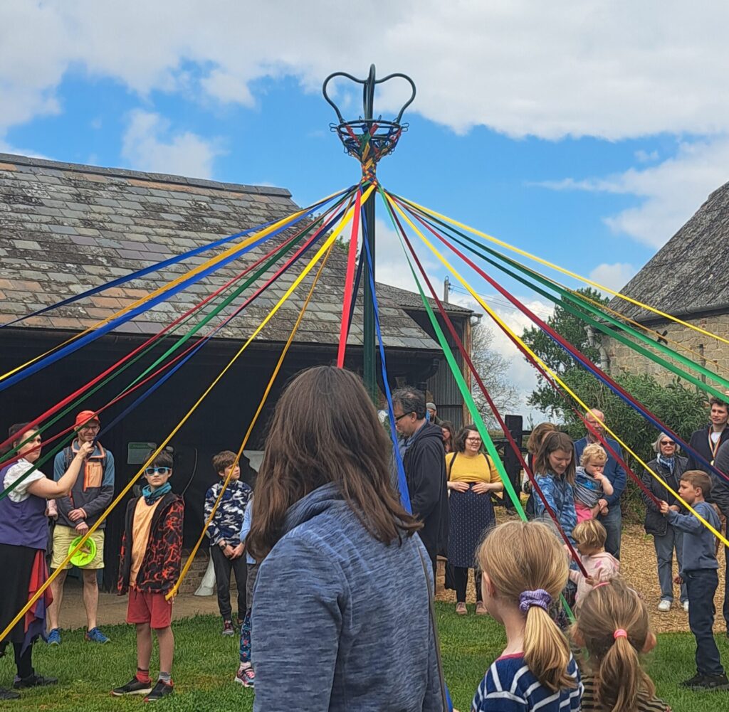 People dancing around a maypole