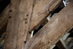 Close up image of wooden beam. Shows roman numerals carved into the beams where they attach.