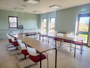 Tables and chairs set in a U-shape for a business meeting