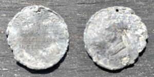 Two sides of a silver coin, a little battered with rough edges